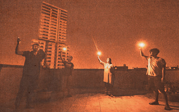 4 people raising candles into the air