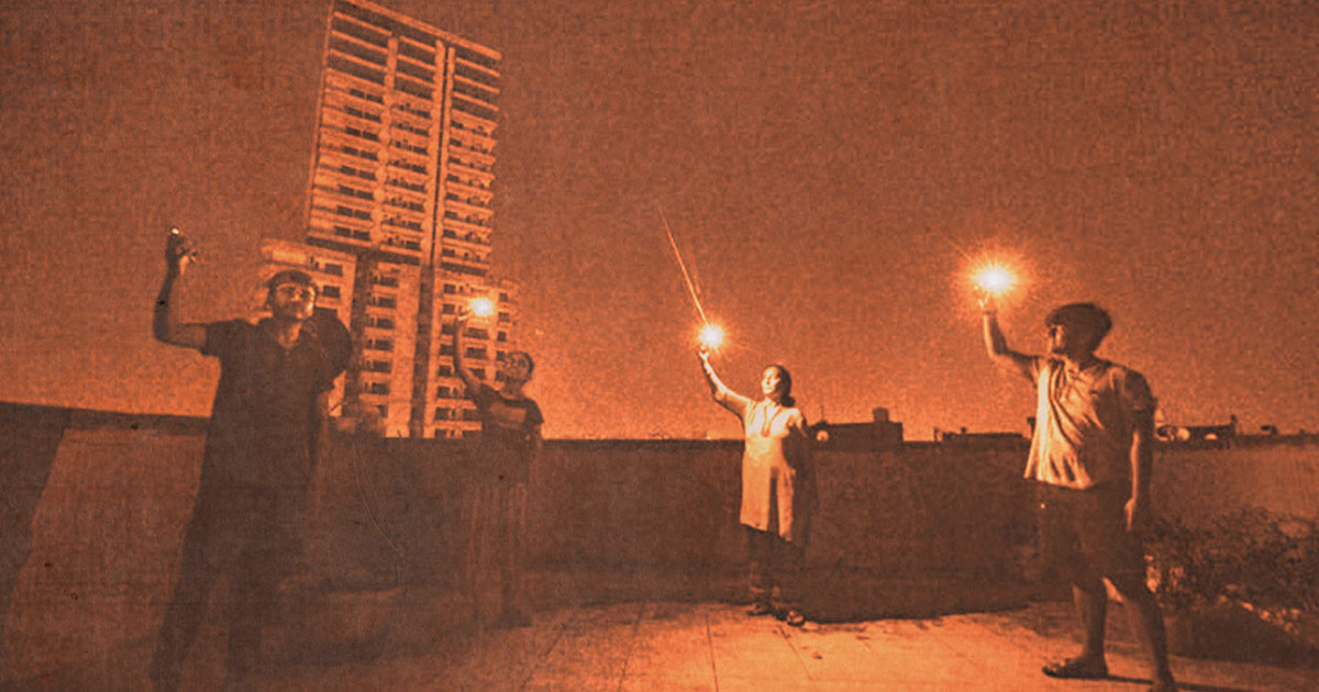 4 people raising candles into the air