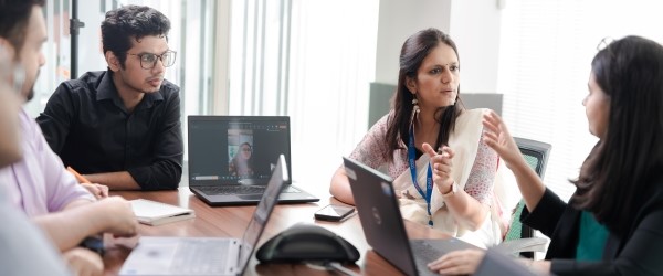 A hybrid meeting of coworkers talking