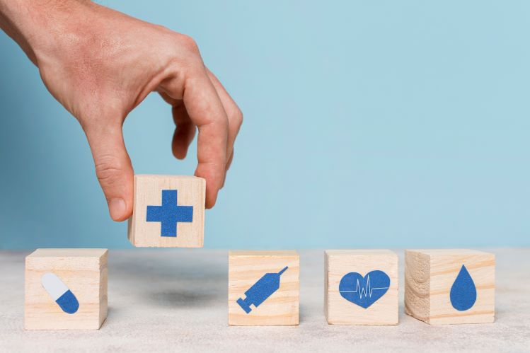 Person placing blocks with health icons